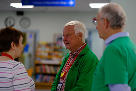 Volunteers in their green jackets/tops