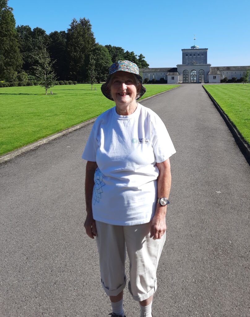 Sandra poses smiling at the beginning of her walk