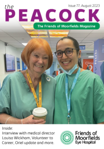 The front cover of the August 2023 Peacock. It shows two volunteers smiling in scrubs.