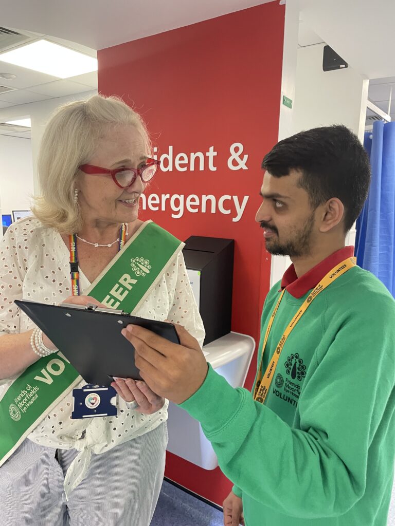 Two volunteers work together in A&E.