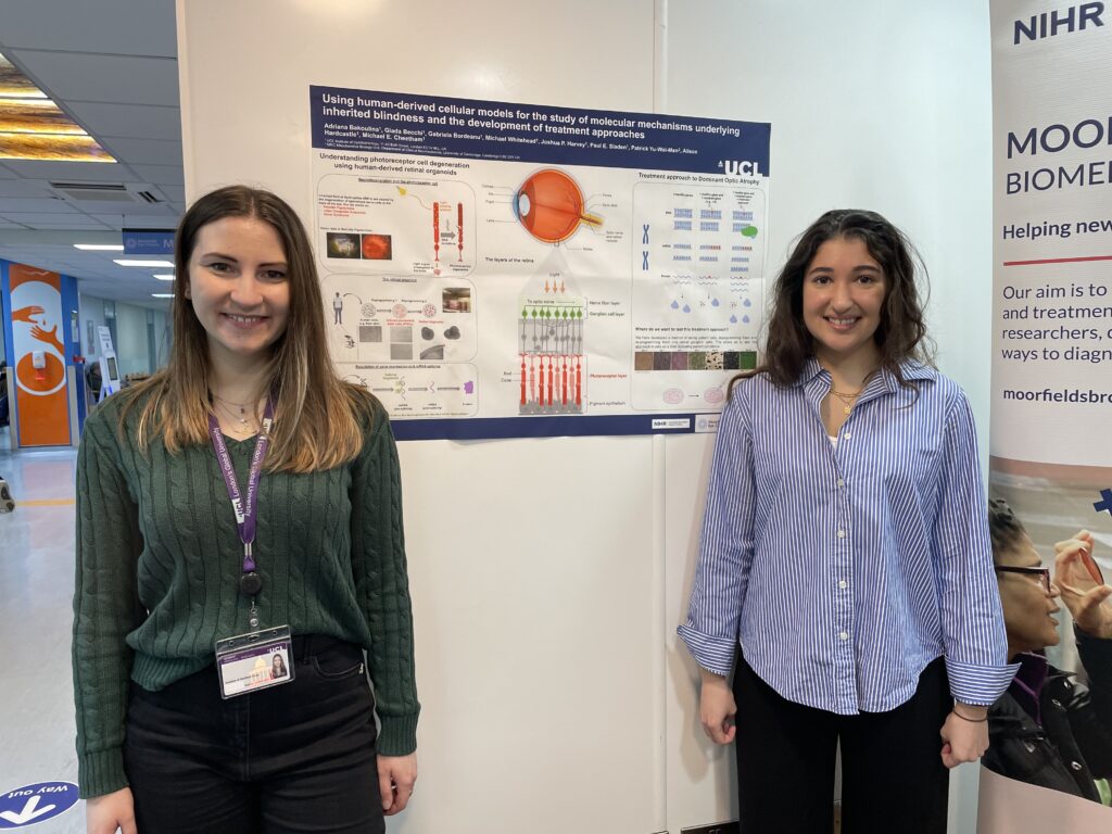 Researchers pose beside a poster of their research.